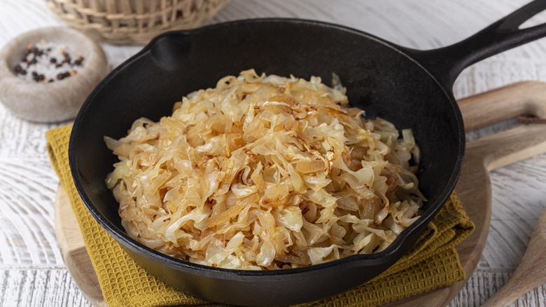 cooked shredded cabbage in a black frying pan