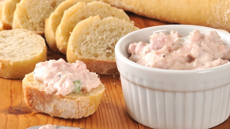 Deviled ham in a ramekin and spread on bread
