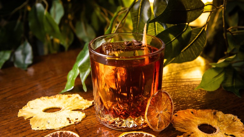 whiskey sour with dried pineapple and citrus