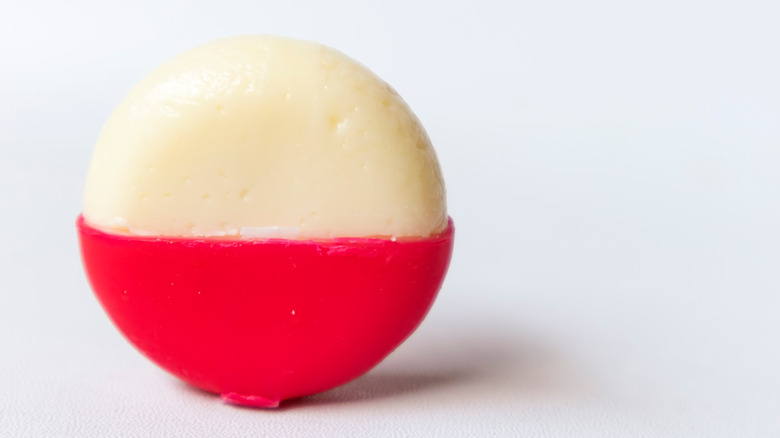 partially unwrapped babybel cheese