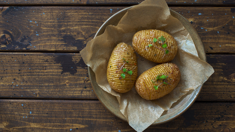 Baked potatoes on a wooden table.
