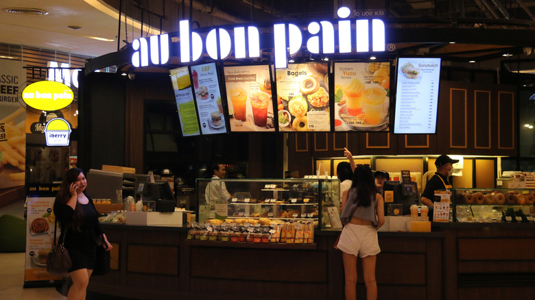 Woman orders from counter of au bon pain in food court