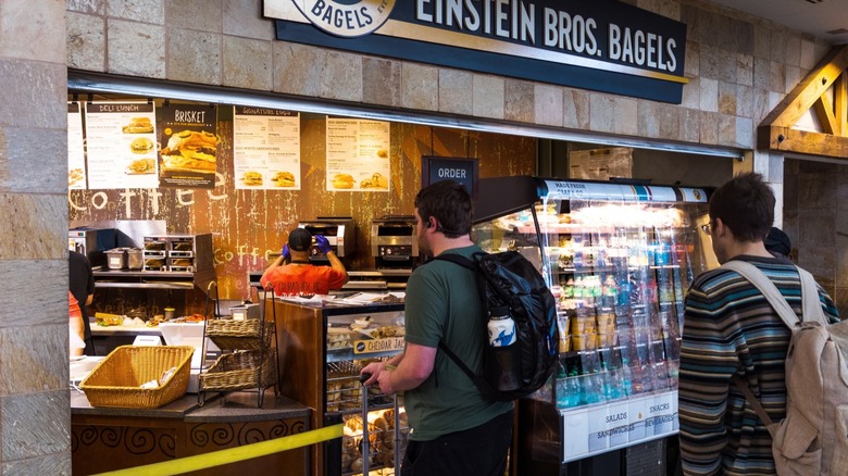 people waiting to order at Einstein bros. bagels counter