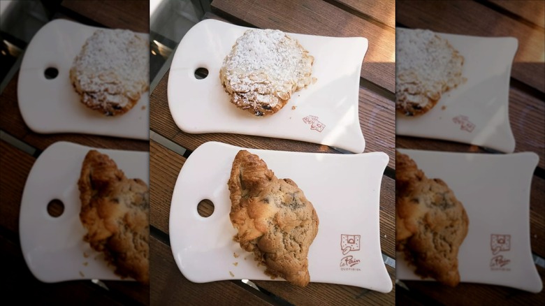 Croissants and crookies on Le Pain Quotidien plates on wooden table