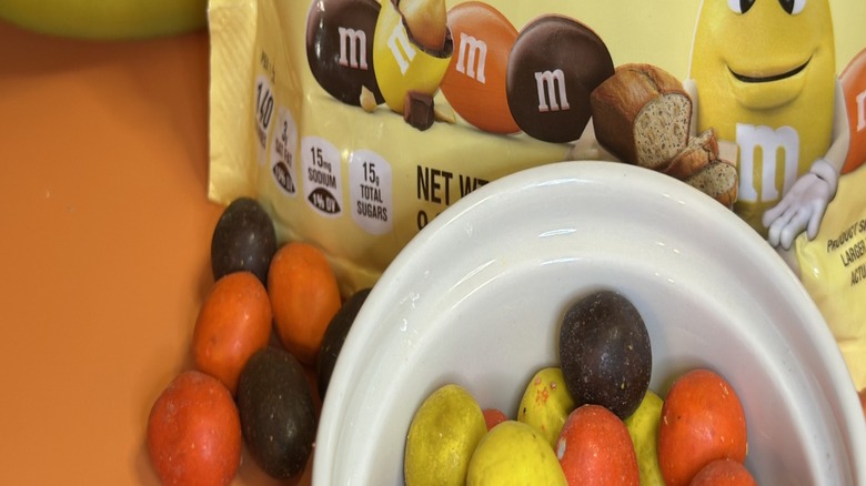 Bag of M&Ms Banana Nut Bread packaging with candies in white ramekin