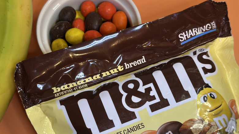 Bag of M&Ms Banana Nut Bread candy with bananas and a ramekin of individual candies