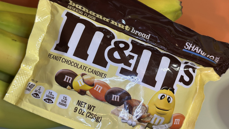 Bag of M&Ms Banana Nut Bread packaging on top of bananas
