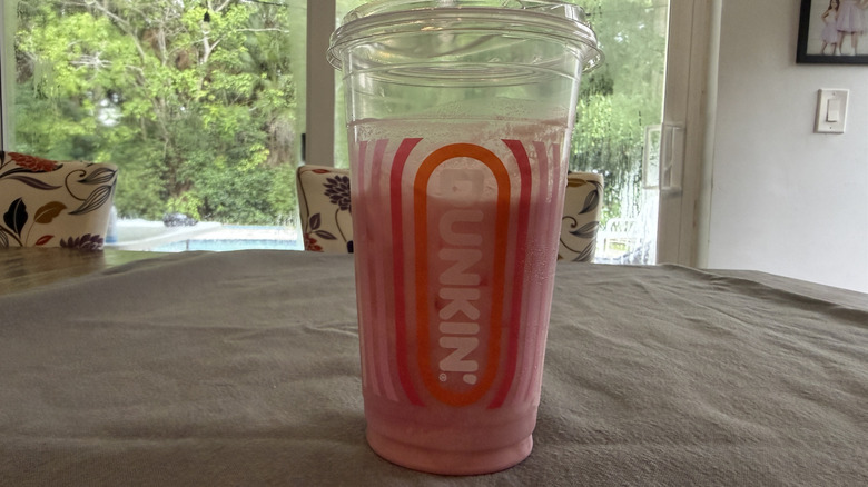 Dunkin' Barbie pink drink on grey tablecloth