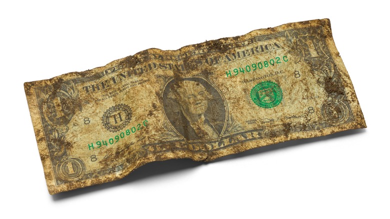 A dirty crumpled dollar bill
