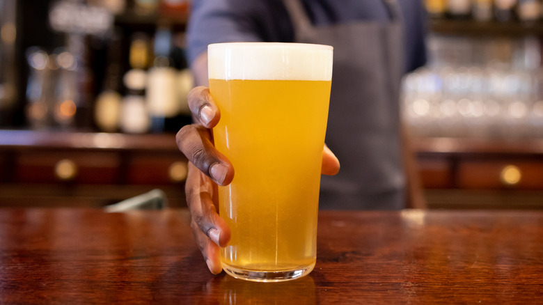 Bartender serving a beer at the bar