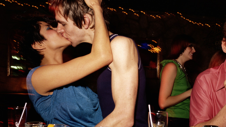 couple kissing at bar
