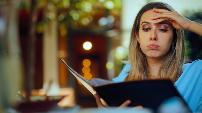 customer looking at menu