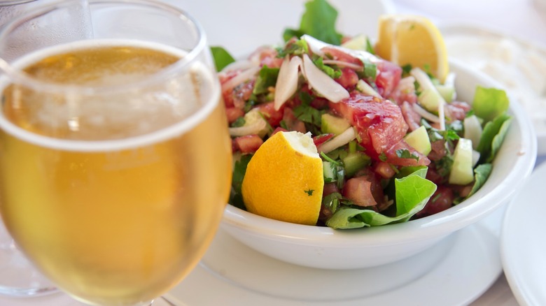 Glass of beer next to salad