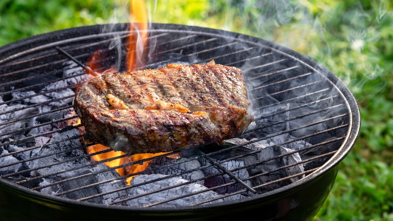 steak on a charcoal grill