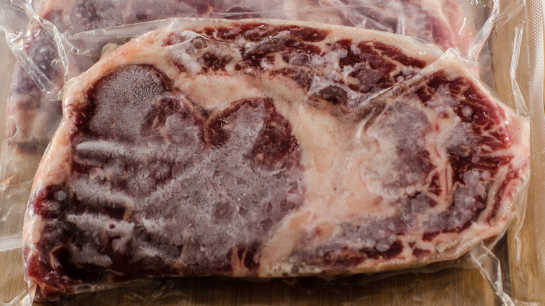 frozen ribeye steak in plastic packaging