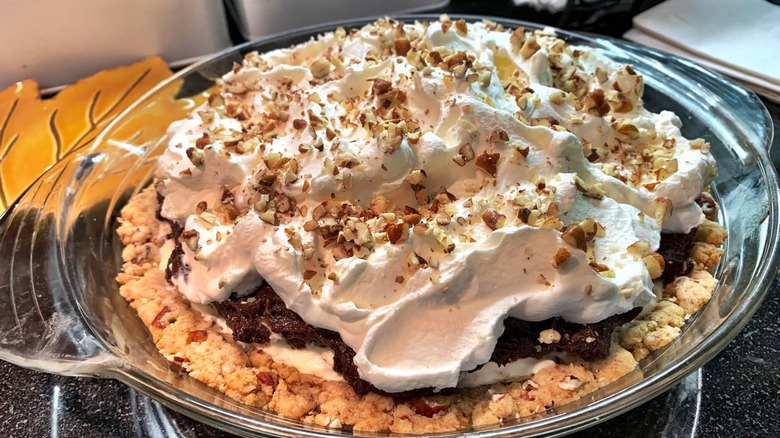 Whole possum pie in a glass dish topped with whipped cream