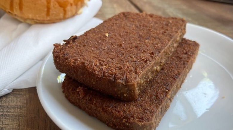 Two slices of scrapple on a white plate