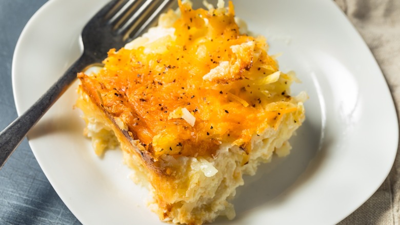 Serving of hash brown casserole on a white plate