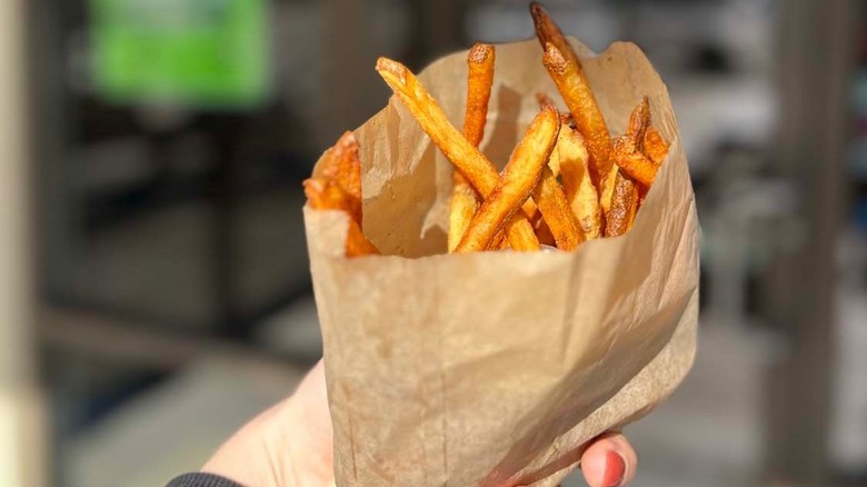 holding sack of fries