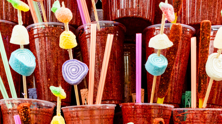 Various chamoy drinks topped with candy
