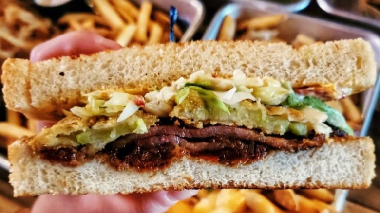 Close-up on Harrie's Jailhouse Southern BLT with fries in background