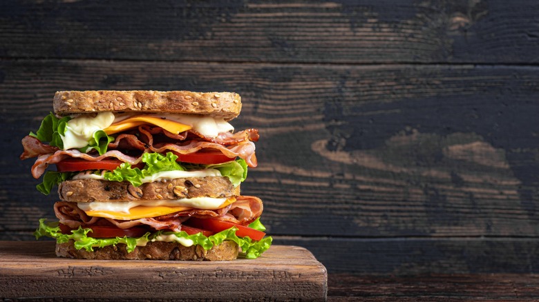 Double BLT sandwich on a wooden surface