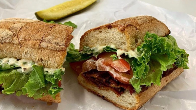 Mitchell Delicatessen BLT with a pickle spear on butcher paper