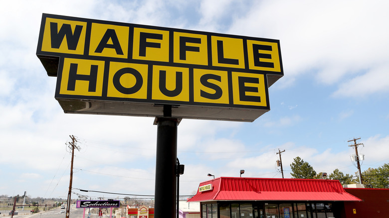 Waffle House Sign above the restaurant and against a blue sky