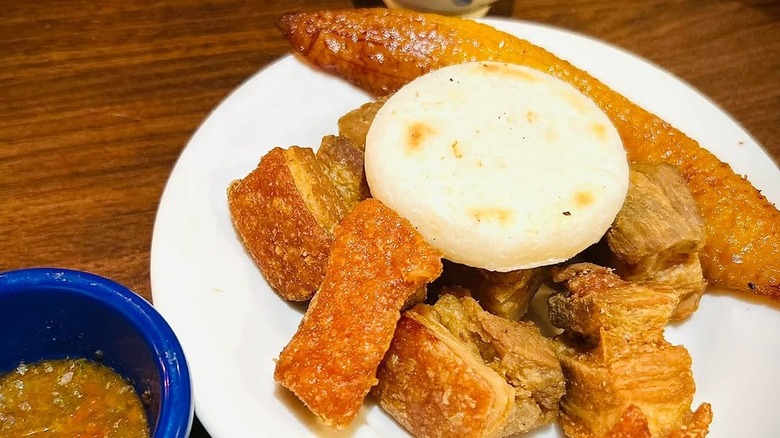 Pork rinds, sweet plantain, and arepas at Mondongo's