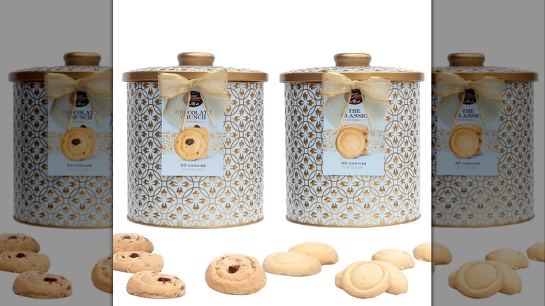 round shortbread cookies scattered in front of decorative tins