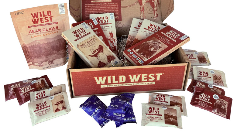 Chocolate candy bars and candy packets with wild west theming in an open box