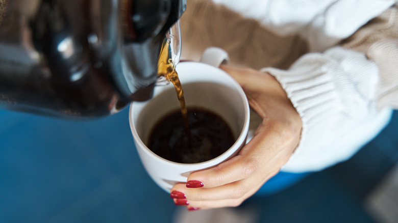 Woman pouring a cup of coffee