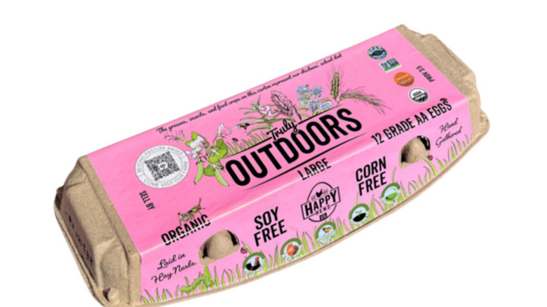 Carton of Happy Hens Truly Outdoors eggs on a white background