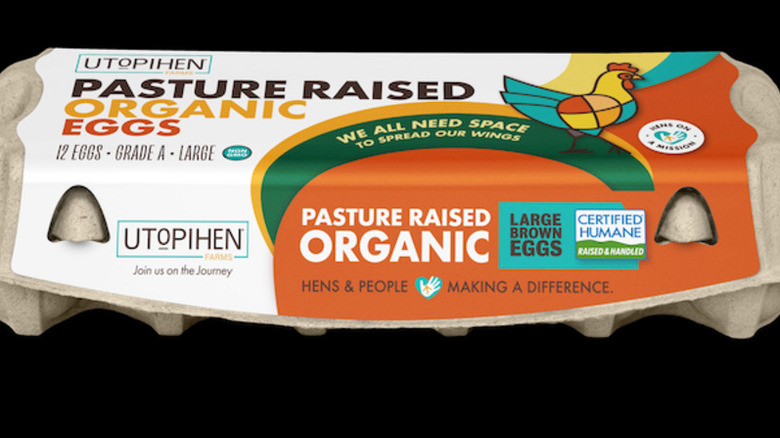 Utopihen carton of eggs on a black background