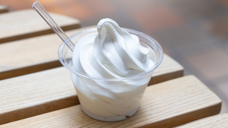 vanilla ice cream in a clear cup with a spoon