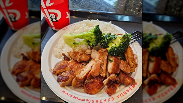 A lunch tray holding a  Panda Express teriyaki chicken and rice plate and a drink