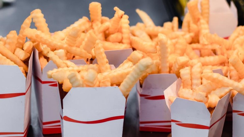 Several crinkle cut french fry cartons standing upright from Sullivan's Castle Island