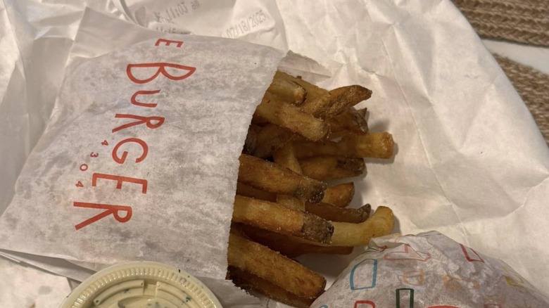 packet of fries with a side of dipping sauce from Le Burger