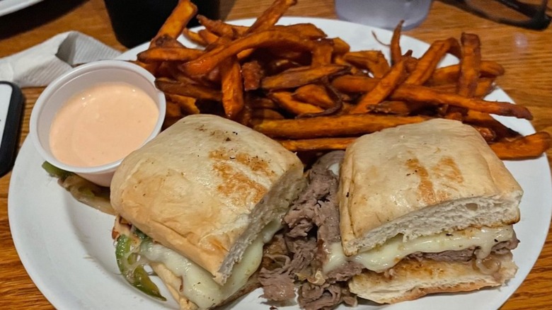 Sweet potato fries beside a burger from Tip Top Kitchen & Cocktails