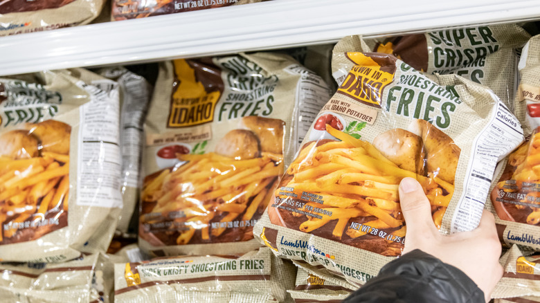 Close-up of hand reaching to grab Made in Idaho frozen fries