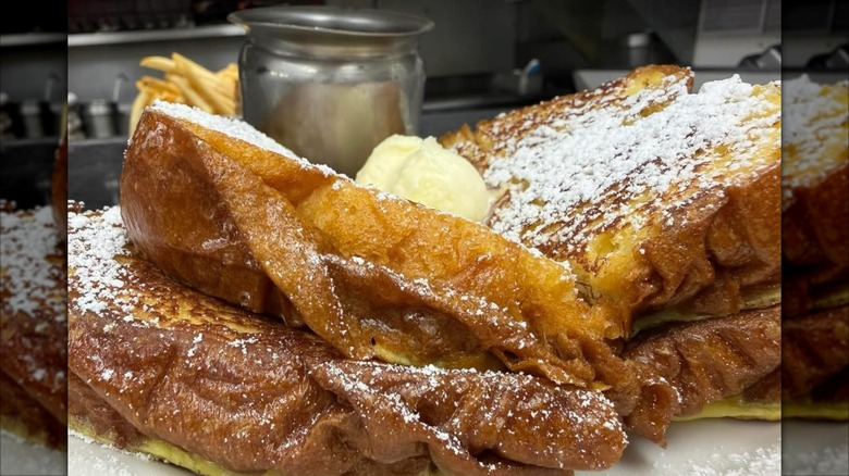 Stack of French Toast with a pat of butter and powdered sugar on top at Jackie's Place restaurant