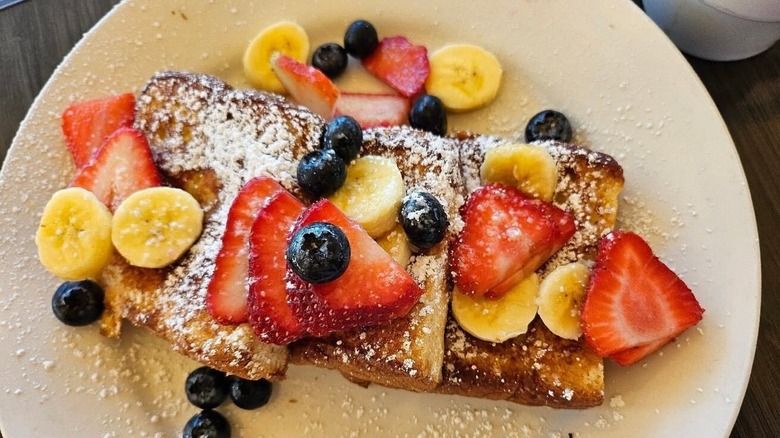 French Toast topped with fresh fruit, strawberries, blueberries, and banana at Sweet E's Café