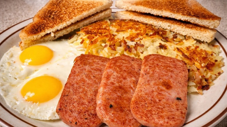 Breakfast platter of eggs, toast, hash browns, and breakfast meats at Ray's Diner