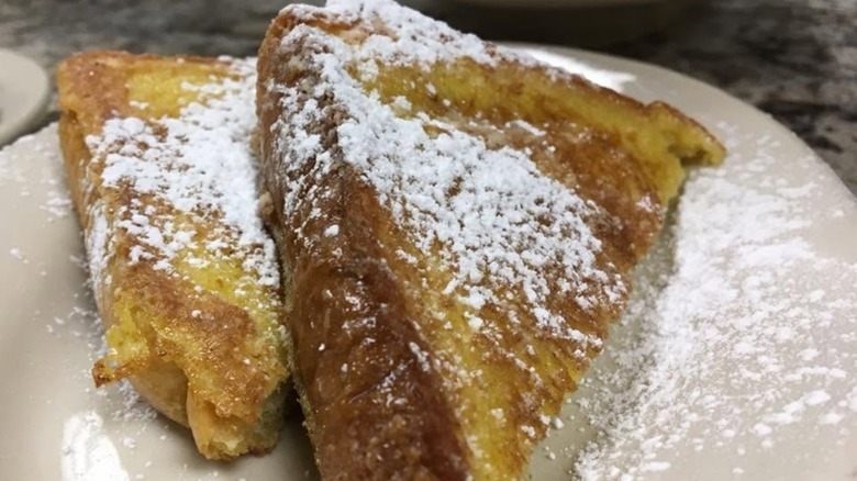 French Toast sprinkled with powdered sugar on plate at Just Judy's Restaurant