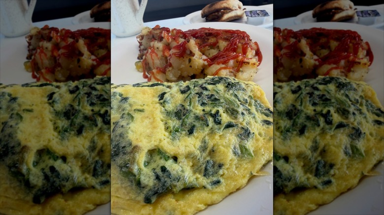 Spinach omelet and hash browns topped with ketchup at Nick's Diner
