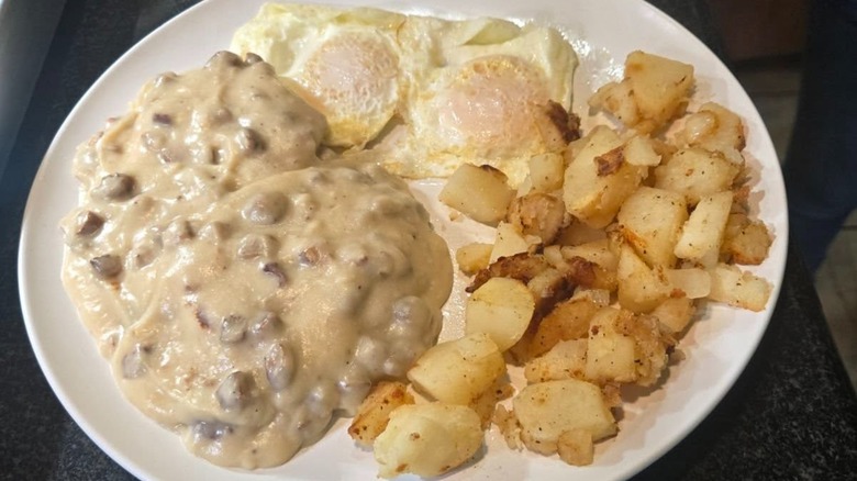 Biscuits and Gravy with breakfast potatoes and fried eggs at Joe's Cafe