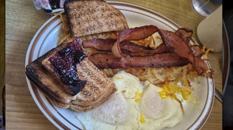 Plate of Fried eggs, toast with jam, hash browns and bacon at Barre Country Diner