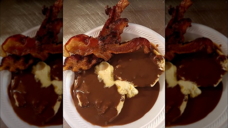 Biscuits with chocolate gravy and bacon on styrofoam plate at Staggs Grocery restaurant