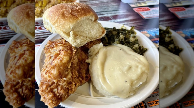 Fried chicken, mashed potatoes, turnip greens, and a yeast roll on plate at Holly's Country Cookin' restaurant