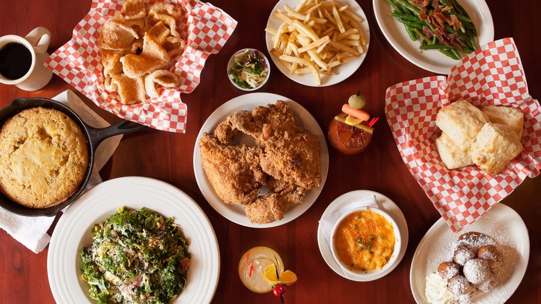 Southern Comfort Food Restaurant Dinner Spread on table with cornbread, green beans, and fried chicken